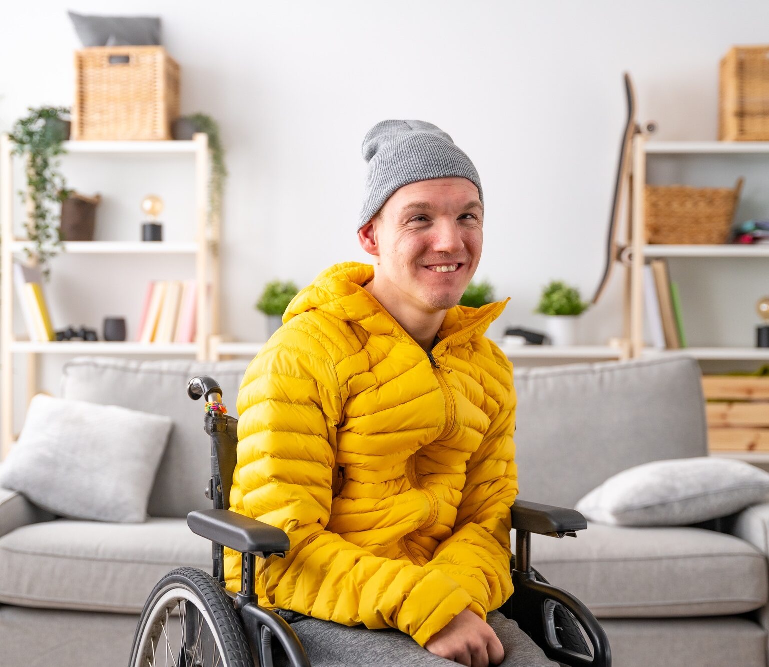 Smiling man with special needs in wheelchair at home
